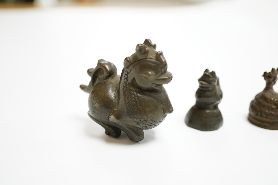 Two 19th century Burmese bronze weights, and a similar figure of a mythical beast, largest 4cm high